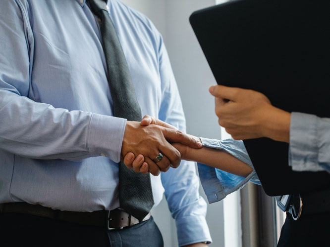 Two business partners shaking hands